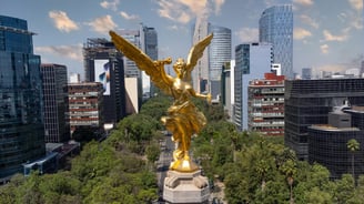 a statue of a golden angel in a city