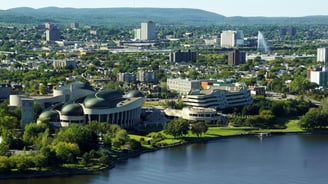 a cityscape of a large building with a large body of water