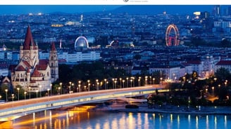 a bridge over a river with a ferris wheel