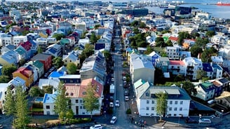 a city street with a lot of buildings and a lot of people