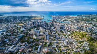 a cityscape of a city with a view of the ocean