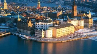 a cityscape of a city with a river and a bridge