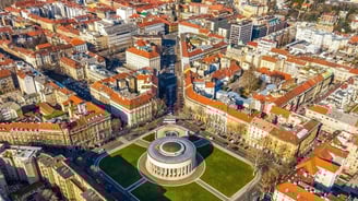a city with a large clock tower in the middle of a city