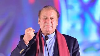 Nawaz Shareef in a local dress suit is giving a speech