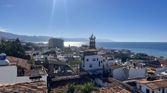a view of a city with a clock tower in the background