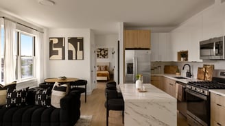 Modern open-plan kitchen and living room with natural light.