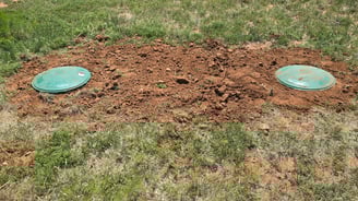 backfilled-dirt-around-new-risers-with-dome-lids-to-TCEQ-standards