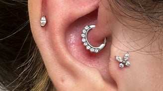 a woman with ear piercings, Tragus piercing, cartilage piercing, rook piercing