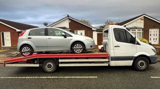 a tow truck towing a car