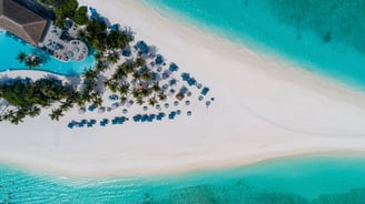 Tropical sandy island with hotel in Baa Atoll, Maldives