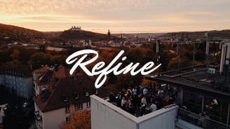 a rooftop with a view of a city skyline and the sun setting in the back