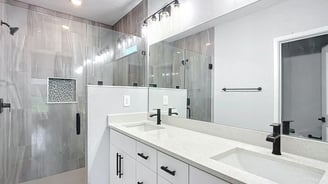 Modern bathroom renovation in Kissimmee with luxury tiling, custom vanity, and updated lighting by F