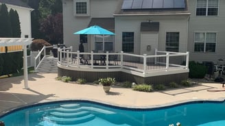 a pool with a blue umbrella and a blue umbrella