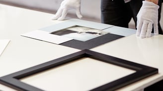 Professional artwork framing in progress at Osner Framing Studio, using archival materials.
