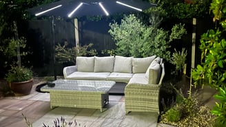 Garden seating area on a sandstone patio, surrounded by mature planting in hemsby