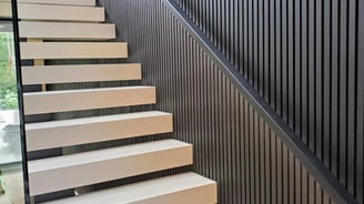 Modern floating staircase design with vertical slat wall feature in a luxury Vancouver home