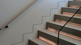 Contemporary staircase design with integrated lighting and minimalist zigzag wall detail