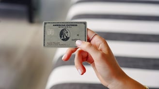 a person holding a silver card with a silver card holder