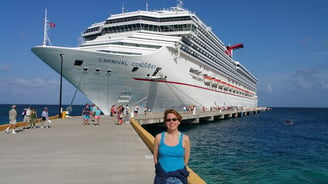 Lady Michelle poses for a pic in front of the Carnival Conquest at Grand Turk Island