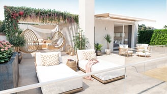 a patio with a white couch and a white couch