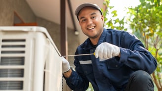 a man in a blue shirt and gloves is holding a wren and wren