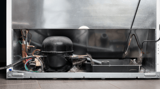 a refrigerator with a large metal container inside