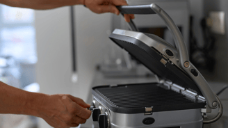 a person is holding a grill grill on a grill