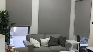 Modern blackout roller blind fully extended blocking out sunlight for complete privacy 