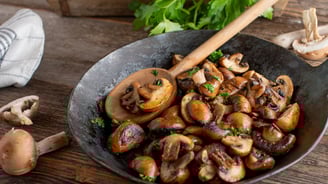 a pan of mushrooms and mushrooms in a skillet