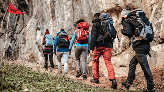 a group of people walking up a hill
