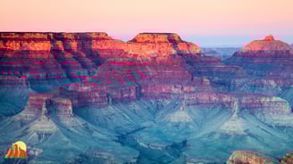 a cliff overlooking a vast view of the grand canyon