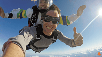 a man and a woman are skydiving in the sky