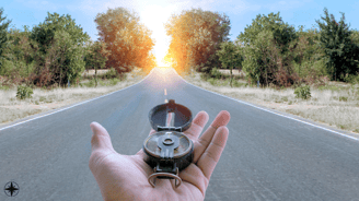 a person holding a compass on a road