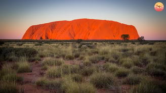 Uluru, alarge rock formation in the middle of a desert in Australia