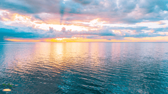 a view of sunset from the sea