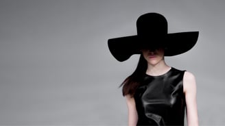 a woman in a black dress and a black hat