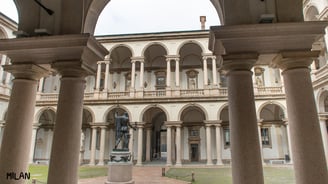 a statue of a man in front of a building