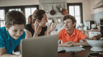 mother homeschooling two sons in the kitchen
