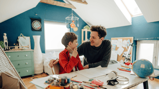 father teaching his child at home