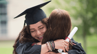 mother hugging homeschool daughter after high school graduation