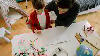 father and son working together on homeschool project