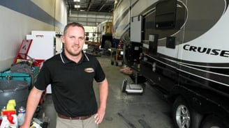 Class A motorhome mechanic performing in shop repair