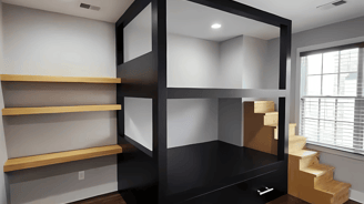 a room with a desk and shelves with shelves