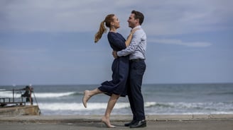 a man and woman standing on a pier