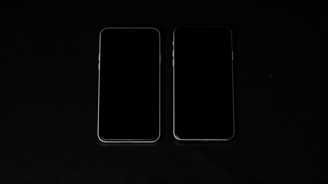 two iphones with a black background and a black background
