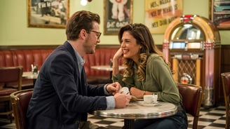 a man and woman sitting at a table in a restaurant