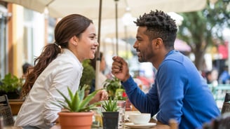 a man and woman sitting at a table