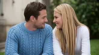 a man and woman sitting on a bench in a park