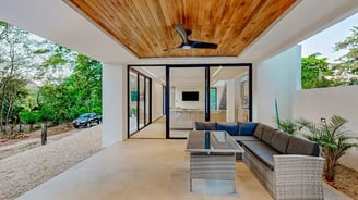 a patio with a couch and a ceiling fan