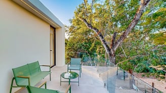a balcony with a bench and chairs and a bench